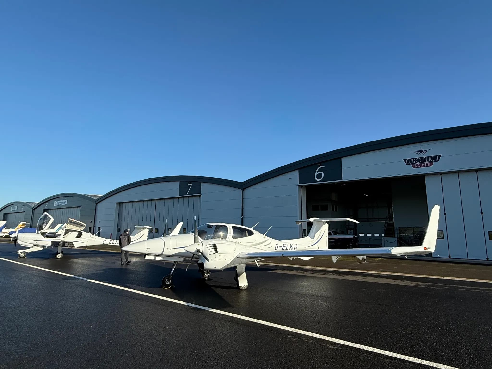 Diamond aircraft on the apron outside the hangars